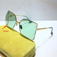 gold frame green lens with letter