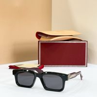 Black silver frame grey lens red legs