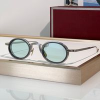 Grey silver frame light green lens